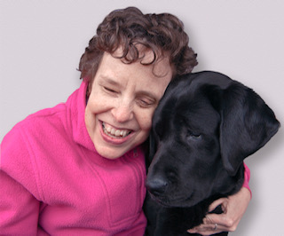 Kim Kilpatrick hugs her guide dog, Tulia
