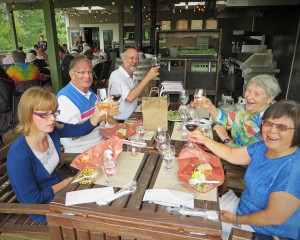 A group of Visionaries members raising their glasses at Creekside winery on our 2016 Bus Trip.